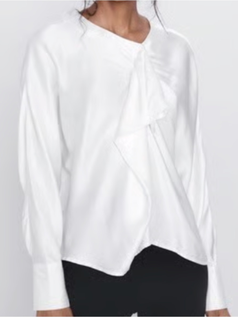 Zara off white satin blouse with asymmetrical ruffle and button closure back.